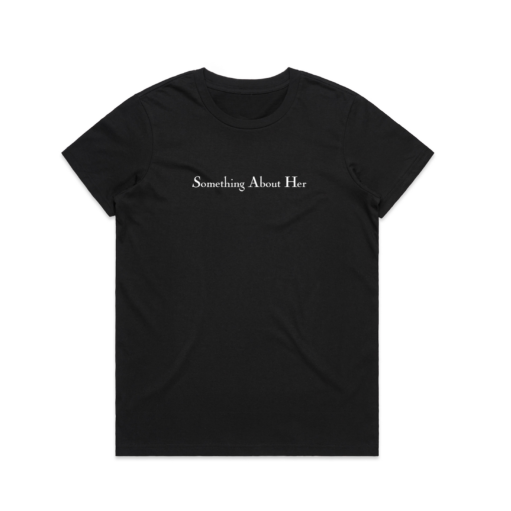 A black women's tee shirt with "Something About Her" printed across the chest in white