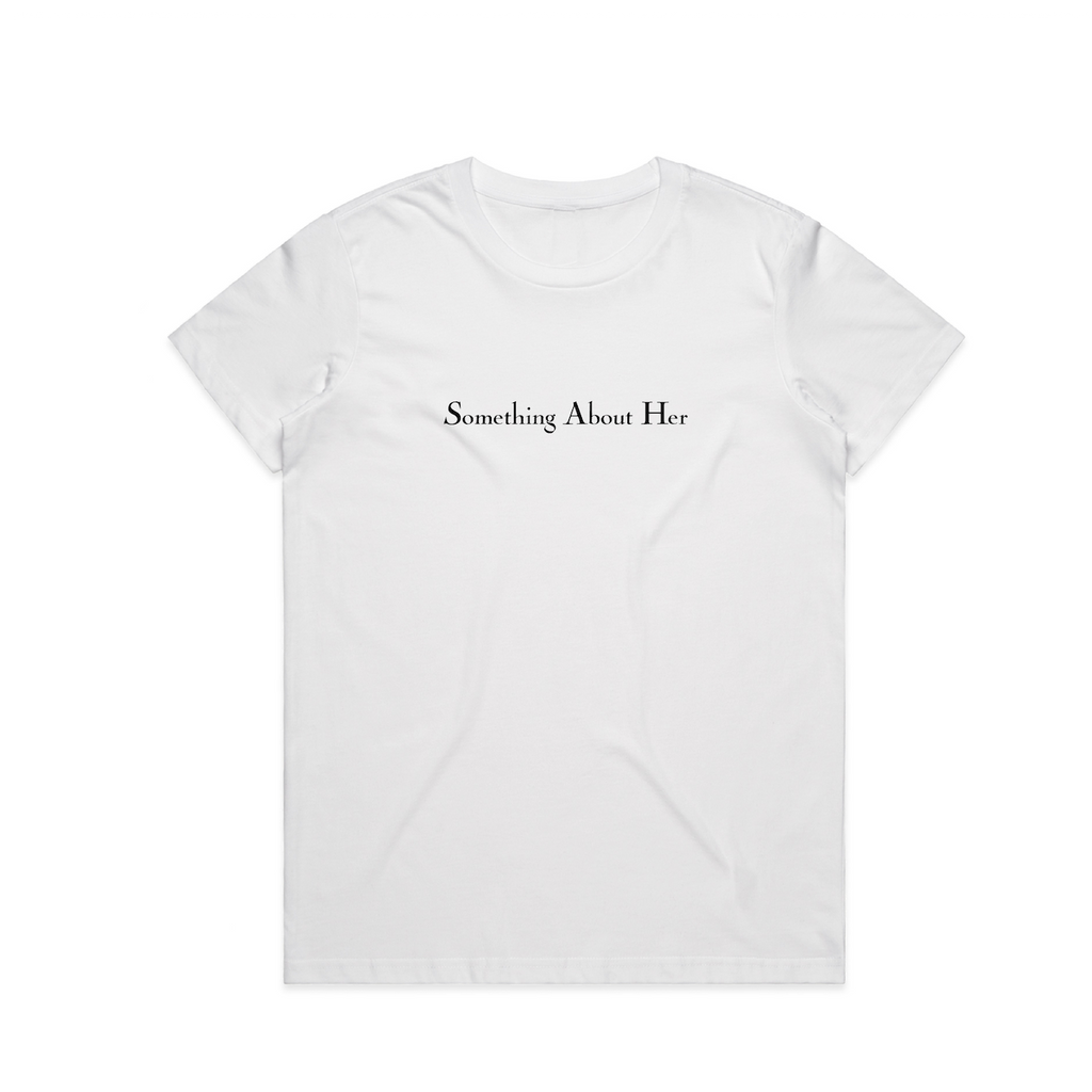A white women's tee shirt with "Something About Her" printed across the chest in black