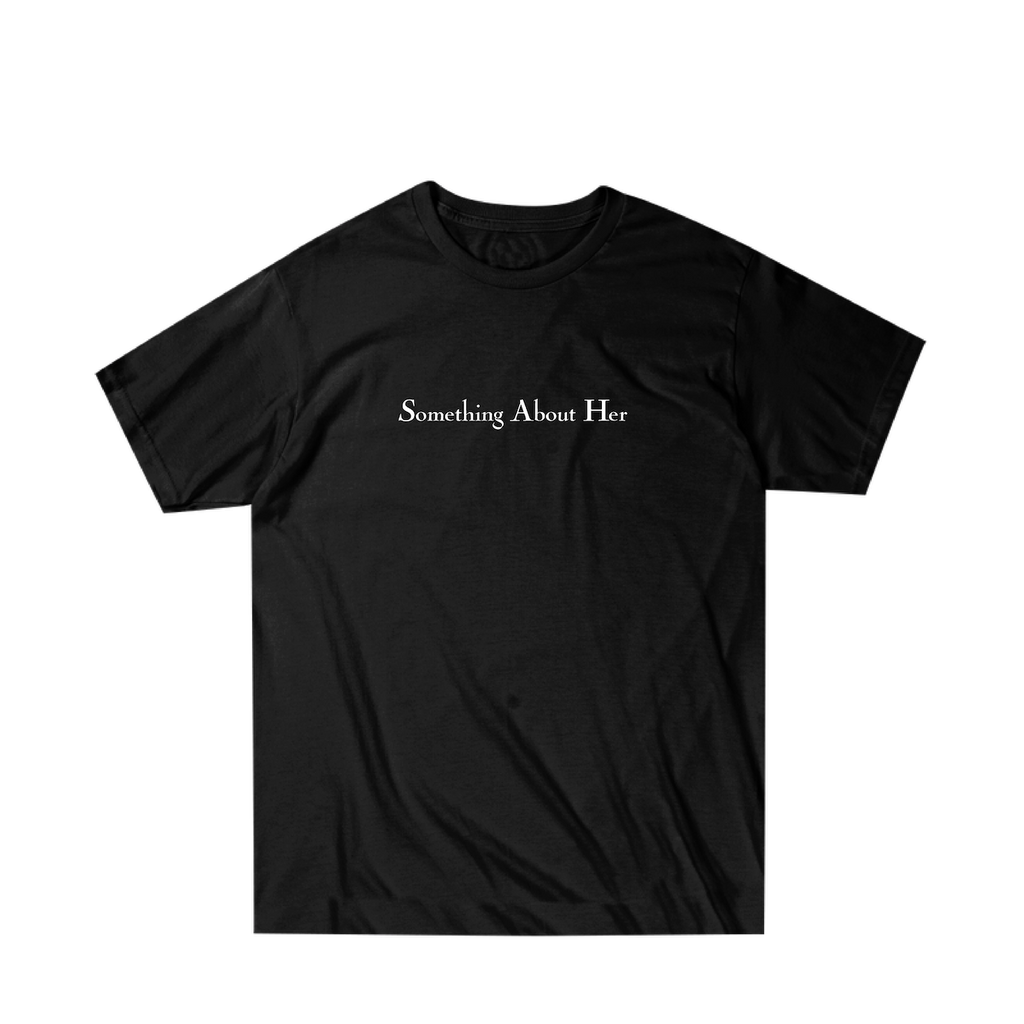 A black unisex tee shirt with "Something About Her" printed across the chest in white 