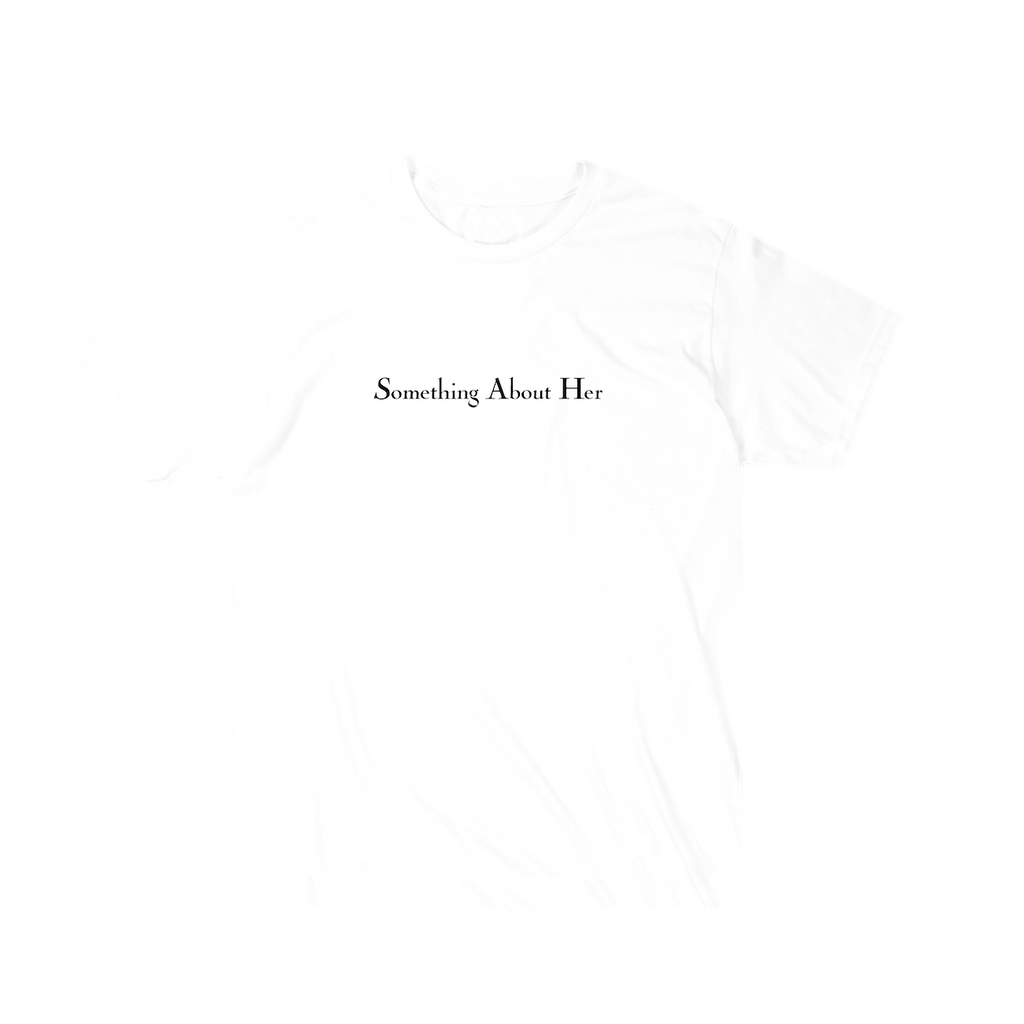 A white unisex tee shirt with "Something About Her" printed across the chest in black 